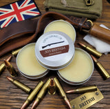 Three tins of '303 British' beard balm on a wooden surface with bullets and a British flag.