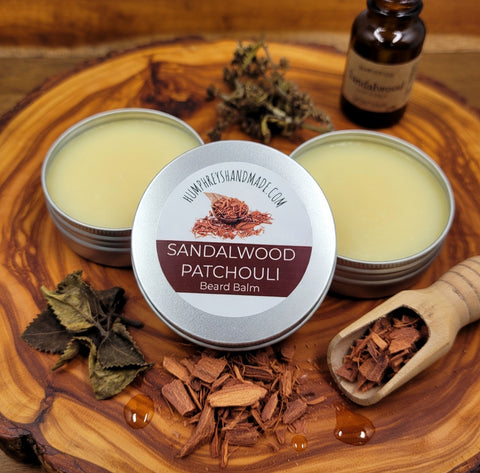 Sandalwood Patchouli beard balm on a wooden surface with sandalwood pieces and a bottle.